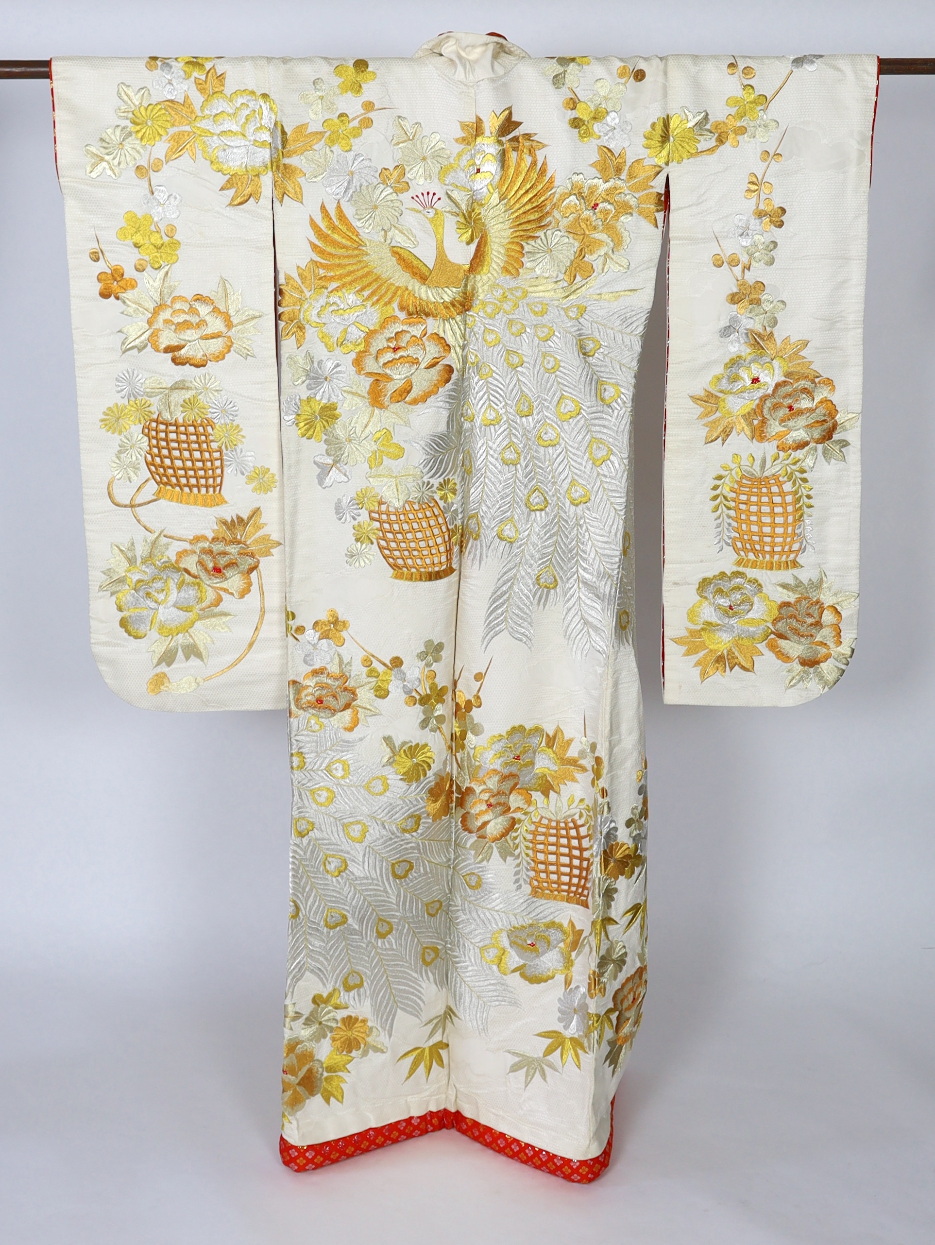 A 1960s-70s vintage Japanese embroidered wedding kimono, embroidered with pewter, bronze, silver and gold coloured metallic threads, into a large decorative design of peacocks with fanned tail feathers and trailing flowe